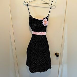 Black Polka Dotted dress with pink belt, tulle, & flower detail.